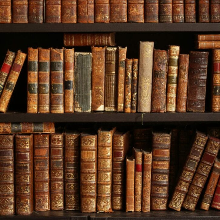 Wooden shelf full of old hardcover books