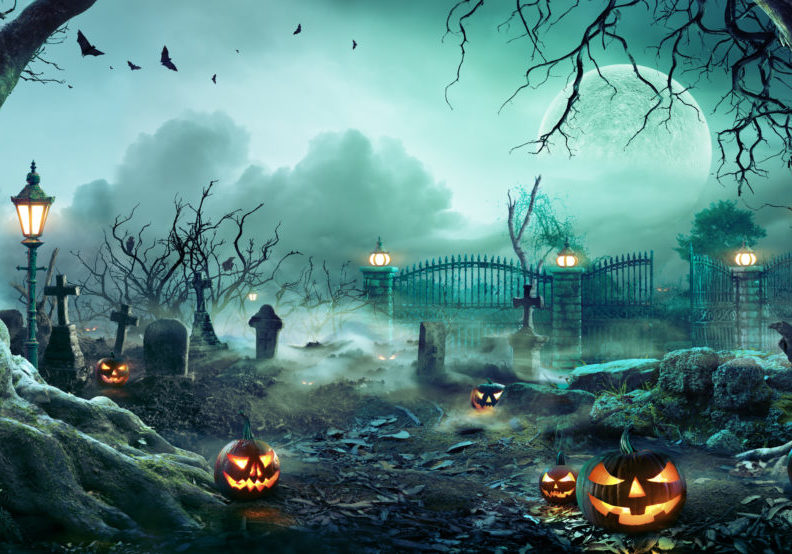 Spooky graveyard scene with headstones and jack-o-lanterns